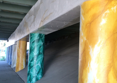 highway underpass pillars painted like marble columns