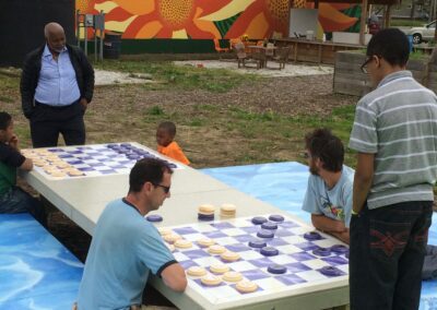 many people having fun playing chess on a giant board