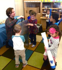 Nick Carpenter showing pre-K students how thunder sheet works