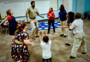 Daniel A. Martin teaching theatre game to group of young studetns