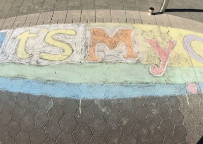 "It's My City" in chalk on sidewalk
