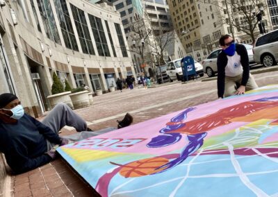 Daniel A. Martin and David Orr assemble basketball mural stage