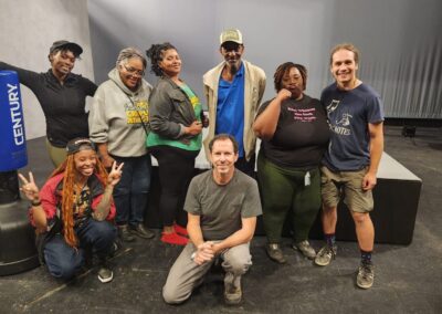 Group of people posing in a studio.