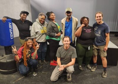 Group of people posing in a studio.