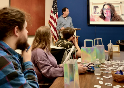 Team meeting with remote presenter on screen
