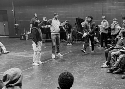 Ensemble rehearsal on a black-box theater stage