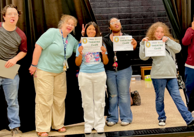 Group of six smiling students holding certificates