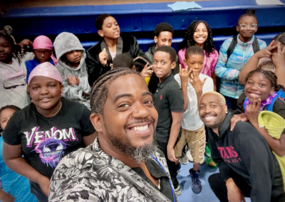Smiling group selfie of children and adults