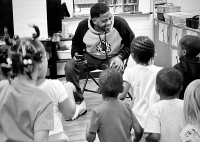 Teacher engaging excited children in classroom circle