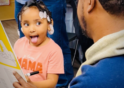 Girl playfully sticking out tongue while reading