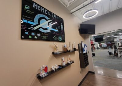 Gym lobby featuring Momenta mural and models