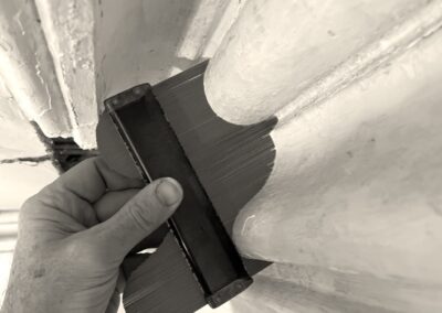 Hand using contour gauge on molding profile