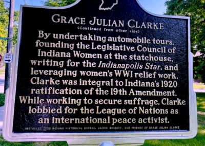Black roadside historical marker sign in park