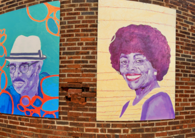 Colorful portrait panels on exterior brick wall