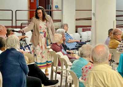 Facilitator offers microphone to senior attendees