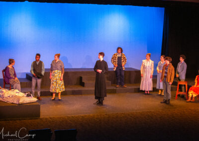 Group of actors on stage in dramatic scene
